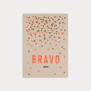 Text Bravo mit Sprenkeln in Gold und fluoreszierendem Orange